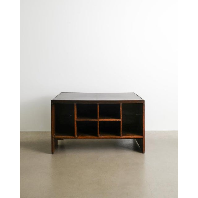 A rare and iconic french mid century wooden "pigeon hole" working desk in dark stained teak and leather by pierre...