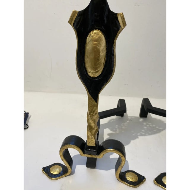 This stylish set of English andirons were acquired from a Palm Beach estate and they are fabricated in wrought iron and...