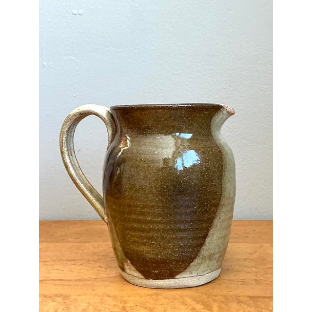 This exquisite original studio pottery pitcher is a masterful display of organic modernism and technical contrast. Hand-...