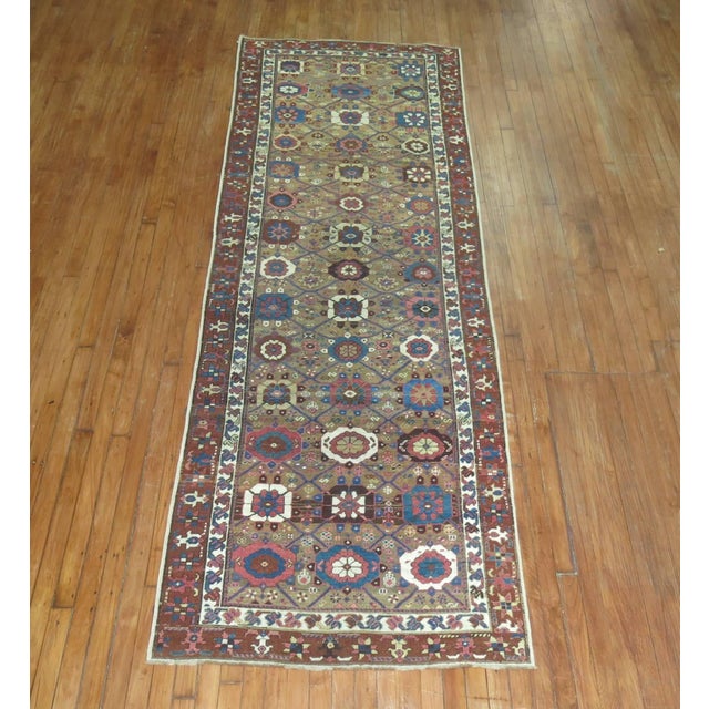 Northwest Persian runner, possibly from Bakshsaish Region with an all-over mini-khani motif set on a camel brown ground...