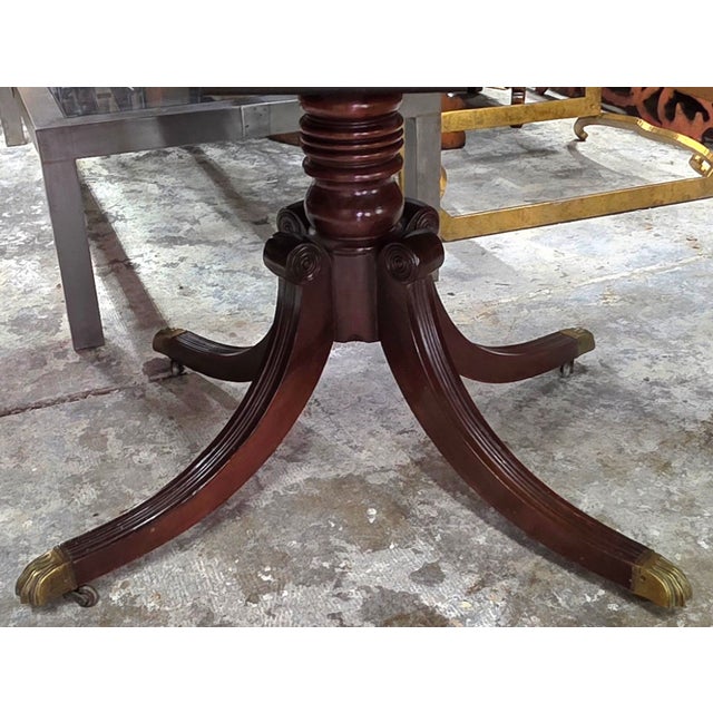 Early 20th Century English Regency Revival Flame Mahogany Oval Extension Dining Table With Satinwood Crossbanding and Brass Paw Feet, Circa 1935 For Sale - Image 5 of 9