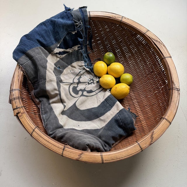 Large Japanese harvest basket in finely woven bamboo, with a broad, strongly reinforced rim and a beautiful shallow form....