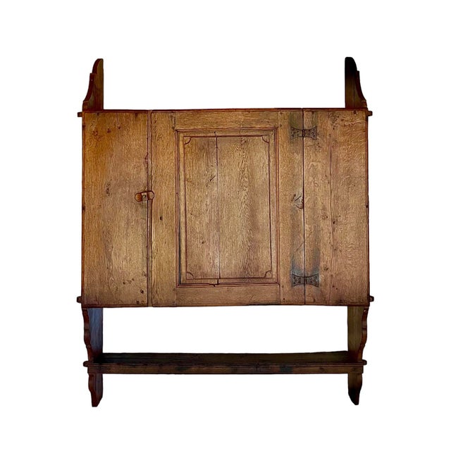 Absolutely gorgeous, this substantial late 18th century wall-hanging cabinet brings all the age-appropriate wear and...