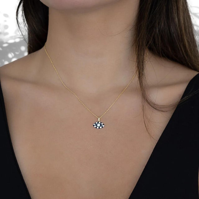 The Evil Eye Design Enamel Pendant Necklace serves as a powerful symbol of protection, intuition, and spiritual...