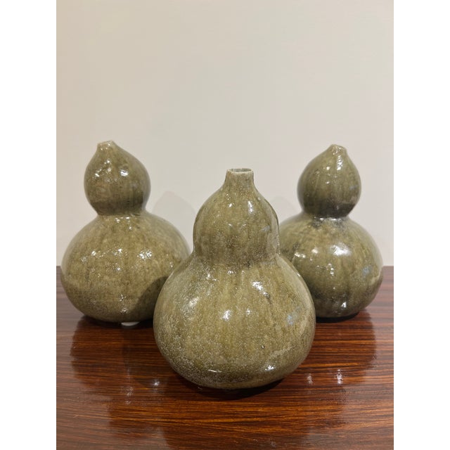 This trio of handmade ceramic gourd vases brings an organic, sculptural element to any interior. Each piece features a...