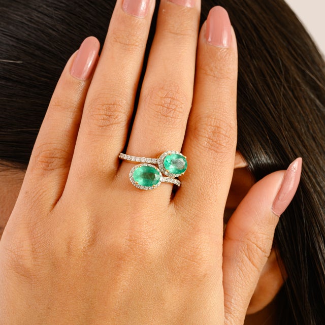 A striking expression of elegance and originality, this bypass ring is crafted in 14k yellow gold and features two vivid...