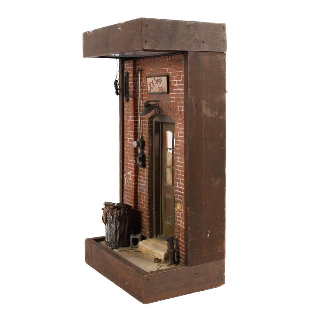 This distinctive cityscape sculpture by Michael Garman captures the gritty charm and quiet storytelling of everyday urban...