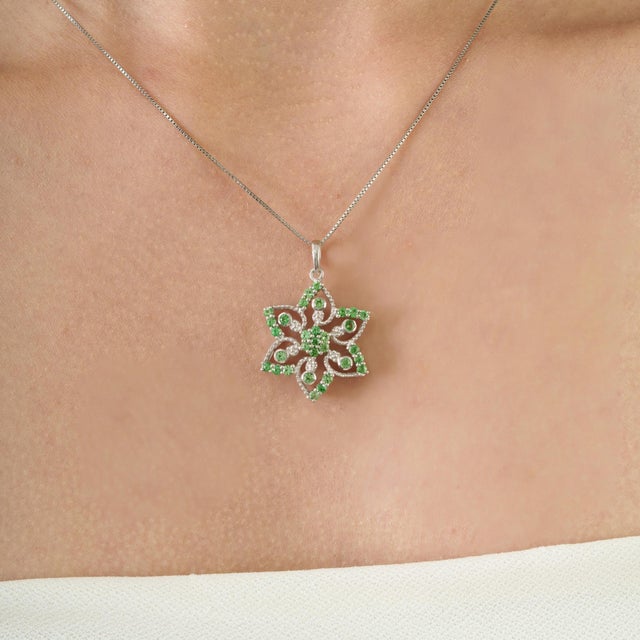 This Art Nouveau-inspired pendant is crafted in 925 sterling silver and features 1.25 carats of round-cut tsavorite...