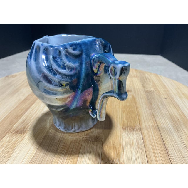 An eye-catching vintage French porcelain creamer crafted with dynamic swirling shell ribs and an angular Rococo-style...