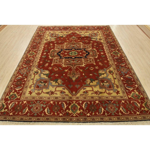 This traditional tribal Serapi rug is hand-knotted with an all-wool pile on a cotton foundation. This rug is new and in...