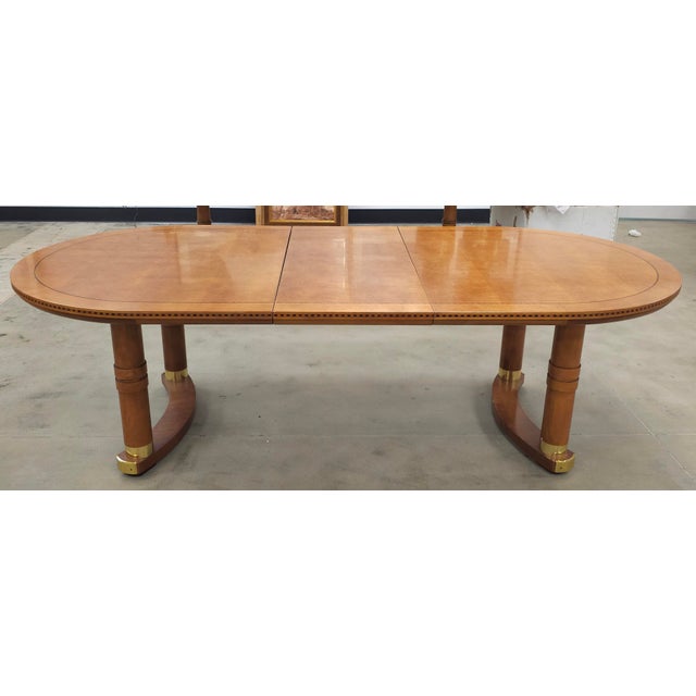 A Hickory White Biedermeier Banded Maple Extension Dining Table with inlays. Two arch legs adorned with brass fittings....