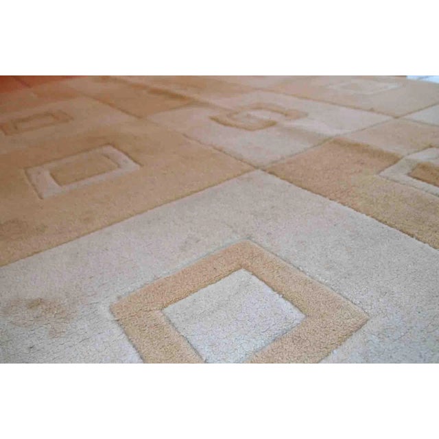 Handmade Chinese rug in light shades of white and brown. It has modern geometric design. The rug made out of acrylic in...