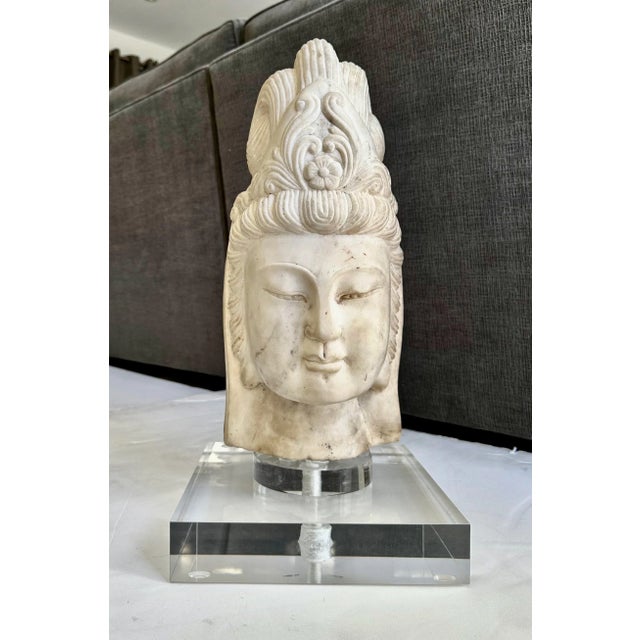 Beautifully executed hand carved marble buddha head fragment of Quan Yin. The youthful face is peaceful and serine framed...