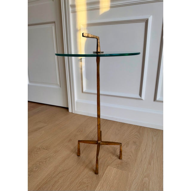 An elegant and increasingly difficult-to-find Quad Pod accent table by Global Views, featuring a sculptural iron base...