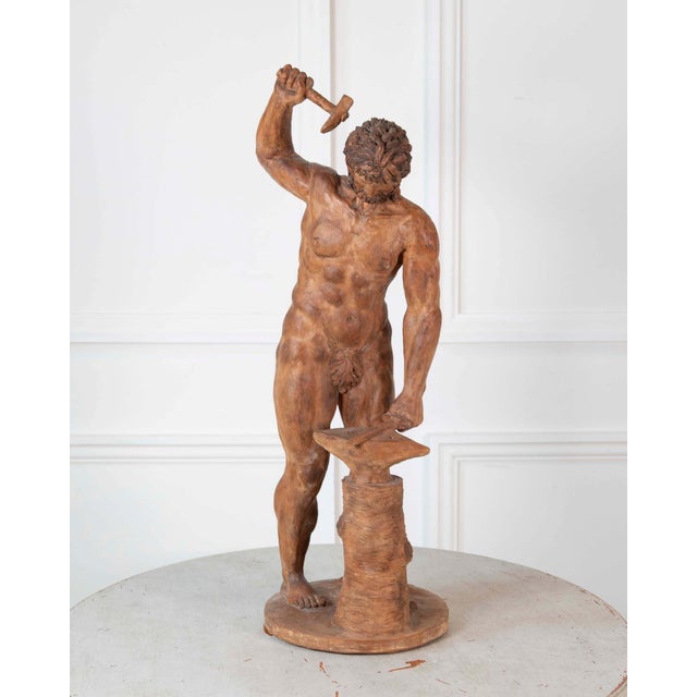 A Greco Roman style Italian terracotta statuette from the 19th century depicting Vulcan, the god of fire. This exquisite...