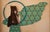 This artwork features a striking figure of a woman, rendered in a blend of realistic and stylized forms, set against a...