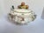 An elegant early to mid 20th-century French faience footed oval tureen. Hand-painted with fruit and leaf decoration....