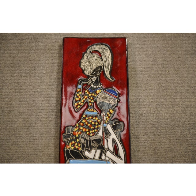 Ceramic wall plaque (San Marino), 1960s, vertical format. Figurative decoration of a stylized couple, rendered in flat...