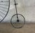 A striking vintage Curtis Jere-style penny-farthing bicycle wall sculpture, handcrafted in welded metal with a black...