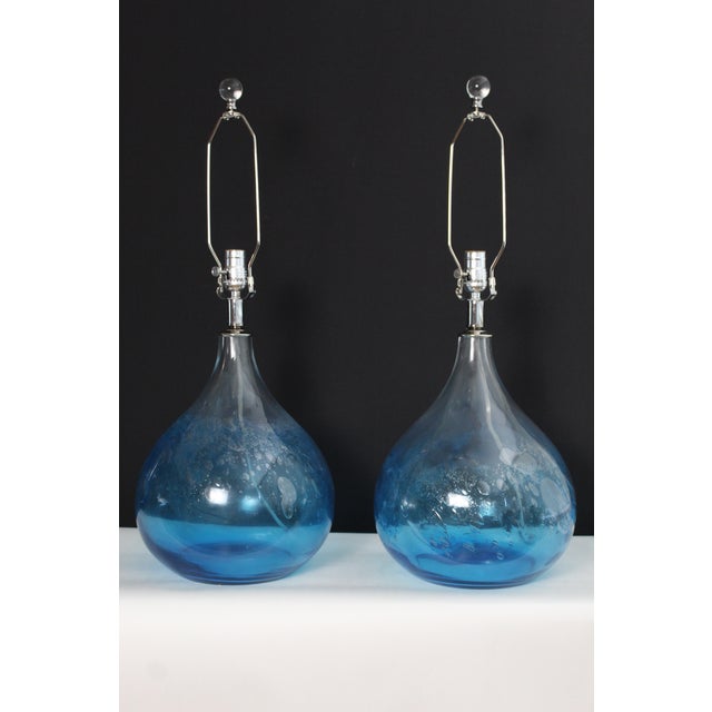 A pair of Mezza Murano style lamps. Boubous hand blown glass. Blended process of deep aqua and transparent and bubbles in...
