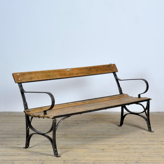 Garden bench from the 1920s. with a heavy riveted iron base. Very nice vintage condition.