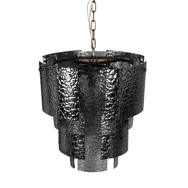 This chandelier features a tiered silhouette made of overlapping textured smoked-glass panels. The cascading design...