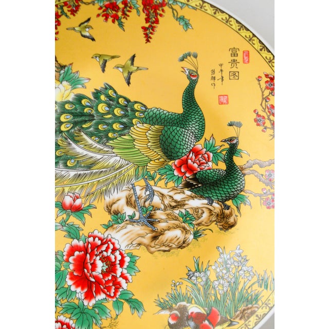This exceptional peacock Chinese Porcelain plate is entirely hand made. On the back of the plate there is a seal/mark...