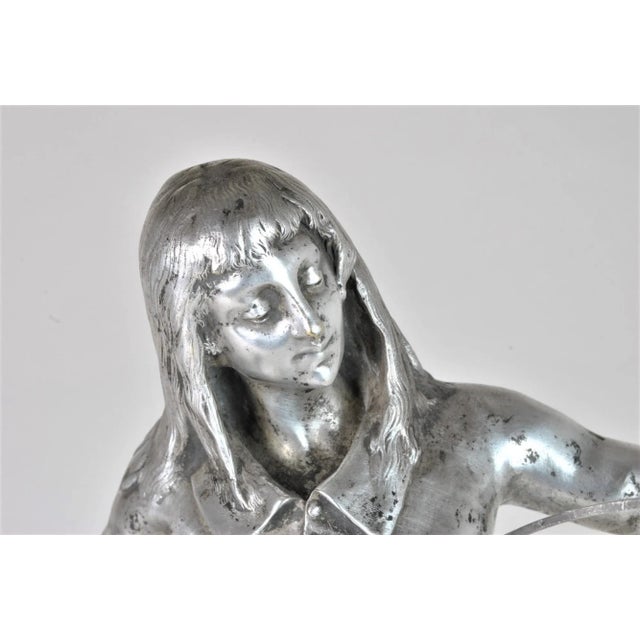 Silvered bronze sculpture, depicting a young man with long hair testing his sword: the base has the cartouche with the...