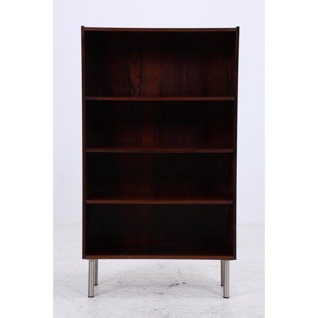 A beautiful vintage rosewood bookcase from the 1960s with a clean, slender form and striking, dark grain. Multiple shelves...