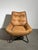 Inviting armchair upholstered in warm cognac leather, paired with a black metal base for an industrial look. Its generous...