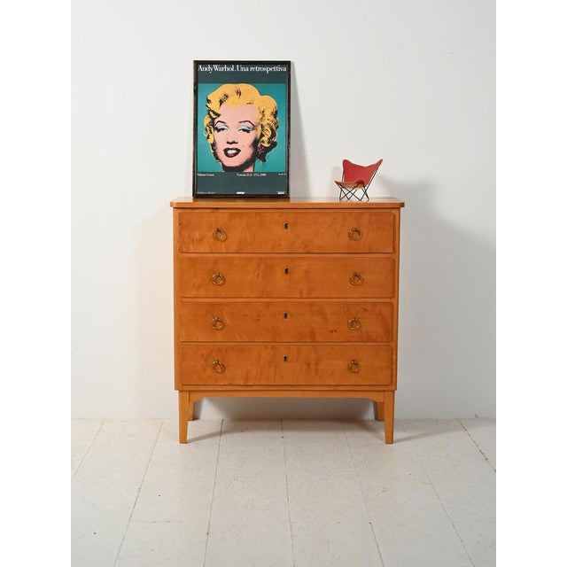 1950s birch chest of drawers with four drawers and round brass handles. Classic lines with elegant Art Deco touches....