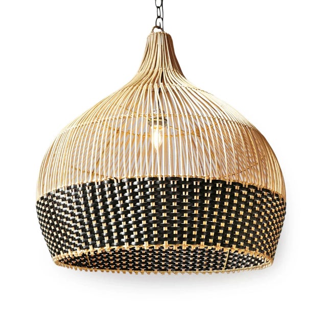 Hand woven pendant light crafted from natural wicker with a striking two-tone weave. The open vertical ribs taper...
