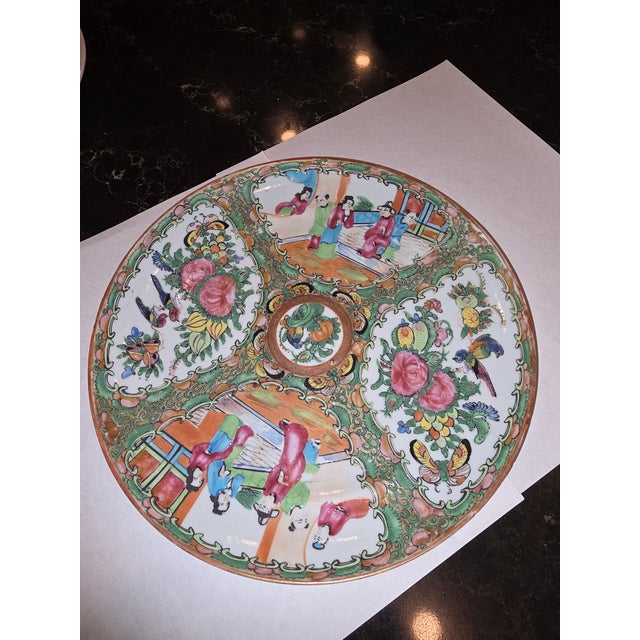 Beautiful 19th century Famille Rose plate. Pretty colors and lots of detailed birds, butterflies, figures and flowers.