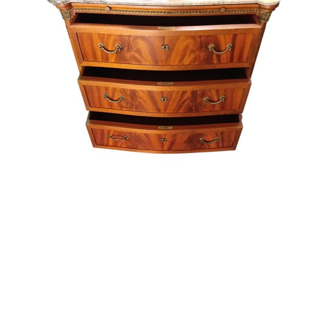 Chest of drawers with brass inserts