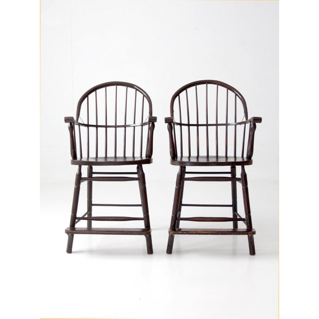 Exceptional pair of antique Windsor billiard chairs, distinguished by their impressive tall scale and elegant continuous-...