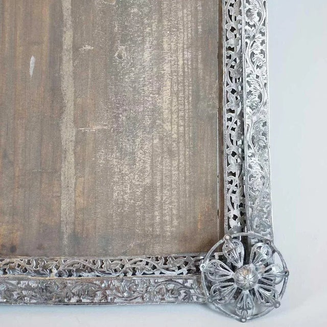 This small antique frame is hand crafted of hammered and cast sheet silver. The design is clearly European, but it was...