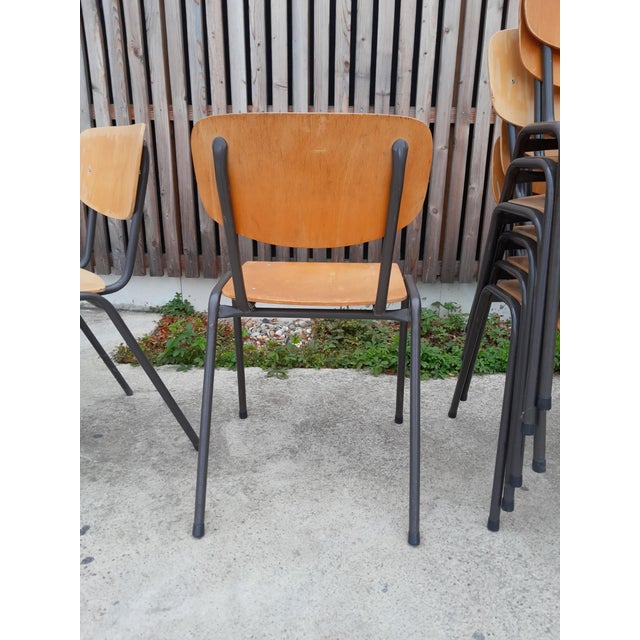 Set of 20 antique vintage school-style chairs. Adult-sized, stackable, and functional. Signs of wear and discoloration on...