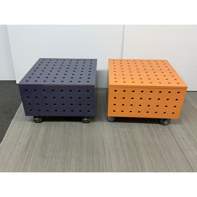 Design Plus Gallery presents a Set of Two Orange + Purple Tables on Casters. The rolling tables can work together as a low...