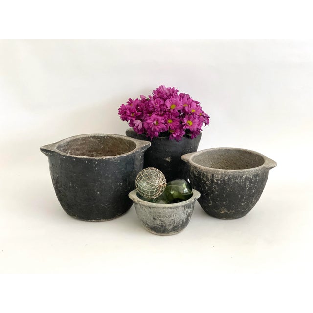 This primitive carved limestone bowl has an organic black and gray texture and lots of patina. Originally used for food...