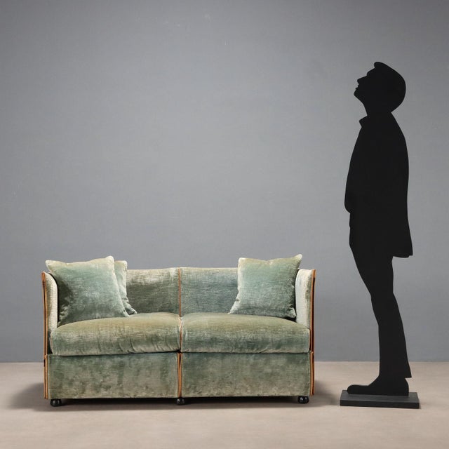 Vintage two-seater sofa with foam padding and velvet upholstery. The sofa is in fair condition with signs of wear as shown...