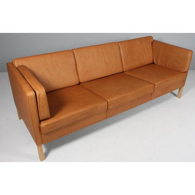 Børge Mogensen three-seat sofa with new cognac vintage full grain aniline leather. Legs of oak. Model 2443, made by...