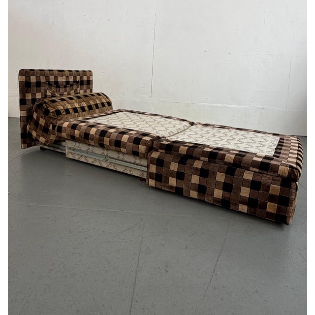 Checkered lounge chair designed for flexibility — one module converts easily into a bed, making this as practical as it is...