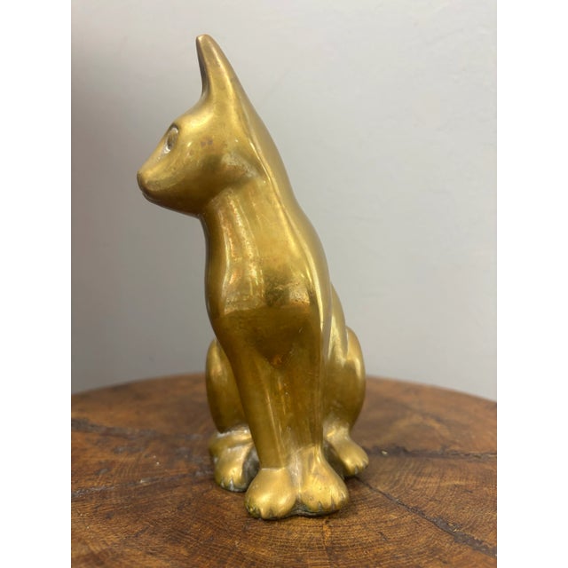 A delightful vintage English brass cat figure, notable for the clean, elegant lines of its casting. The form is simple yet...