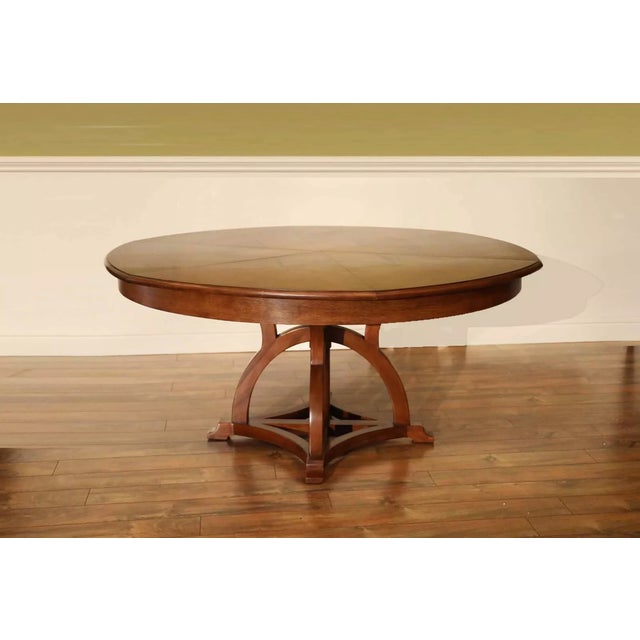 This large Jupe dining table is solid walnut and has an Arts and Crafts-style pedestal. It can be used from 64 to 84...