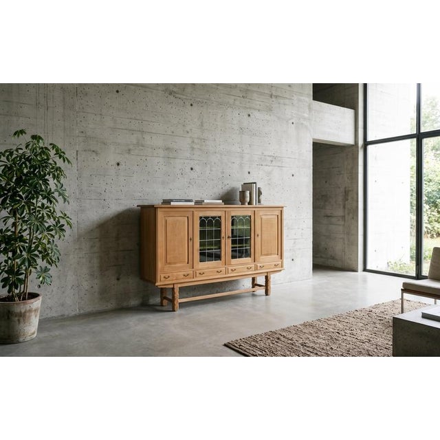 Striking Danish Brutalist highboard in oak, dating from the 1960s. The cabinet features distinctive leaded glass panels in...