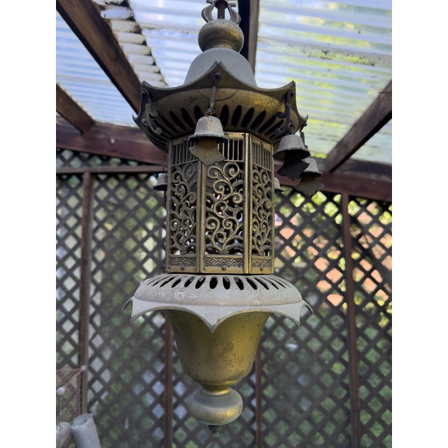 Vintage 1970s Hollywood Regency brass pagoda lantern pendant light with pierced metalwork and a classic Asian-inspired...