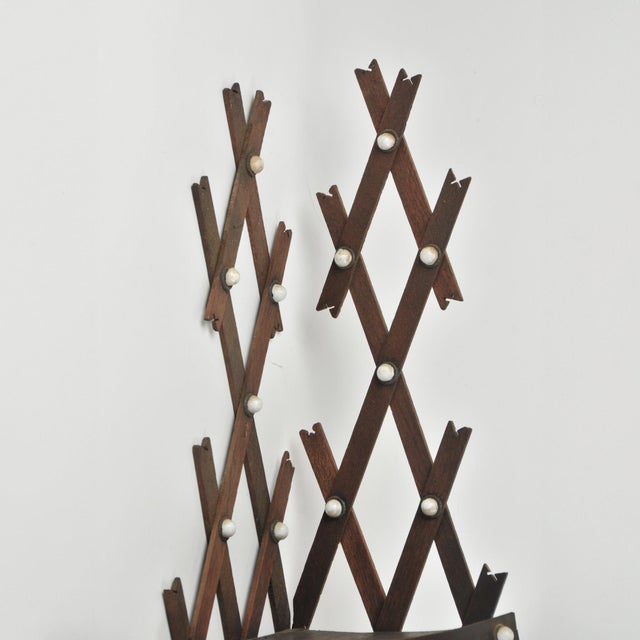 Unique Victorian three tier wall hanging corner shelf in a dark walnut wood with lattice backing and porcelain buttons...