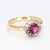 This is a lovely 18k yellow gold ring with a central rhodolite garnet surrounded by a halo of twelve 2mm VS2/F diamonds....