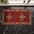 This striking vintage Oushak mat immediately draws the eye with its vibrant red field and bold geometric cross motifs....