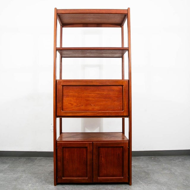 Freestanding teak shelving unit with storage. Finished on all sides so it can be used as a room divider. Features 2...